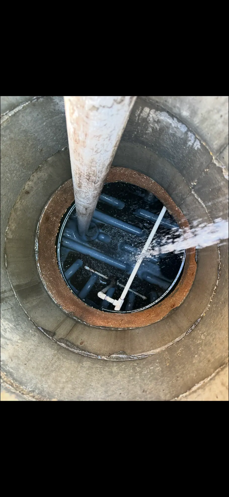 Water spraying inside a round concrete tank
